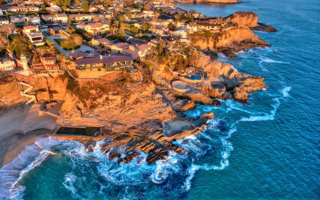 Aerial view of luxury homes on a cliff overlooking the ocean in Laguna Beach, California.